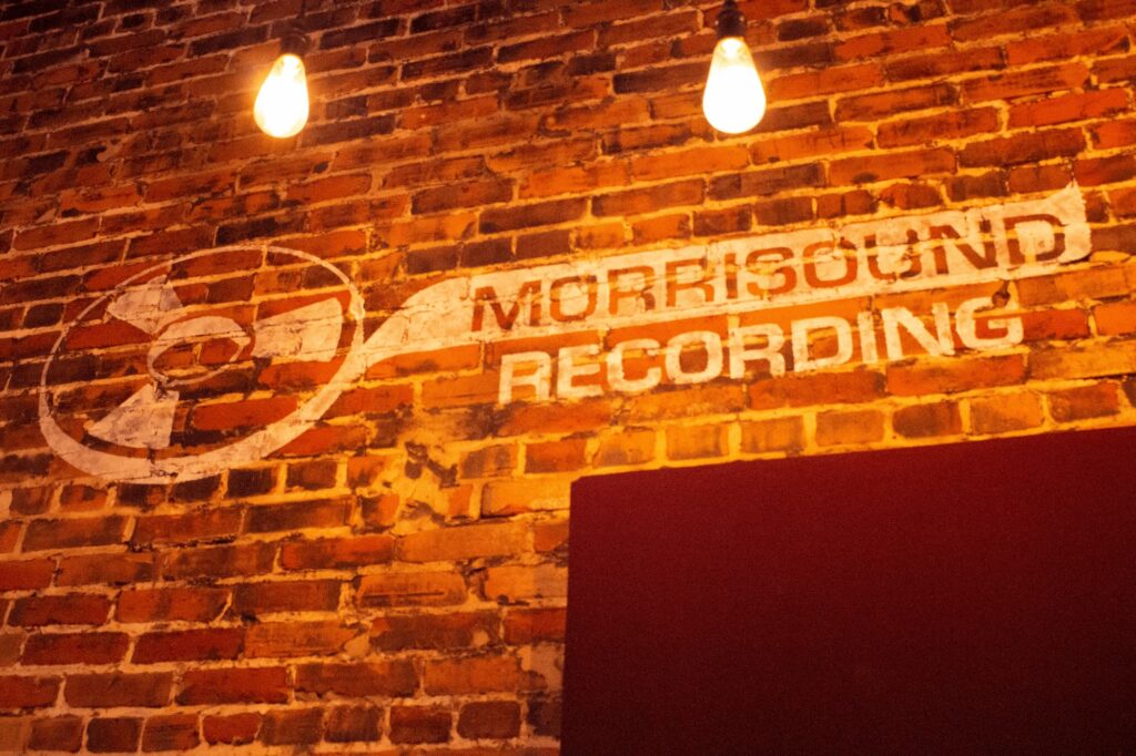 Original Morrisound Recording logo on a brick wall lit by Edison bulbs