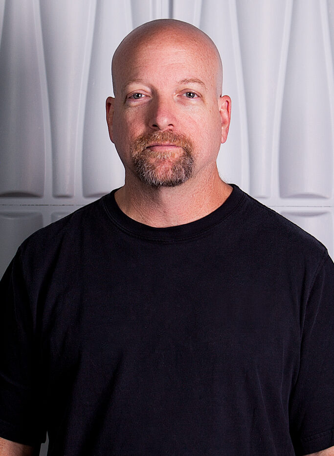 Jim Morris in front of a white, textured background
